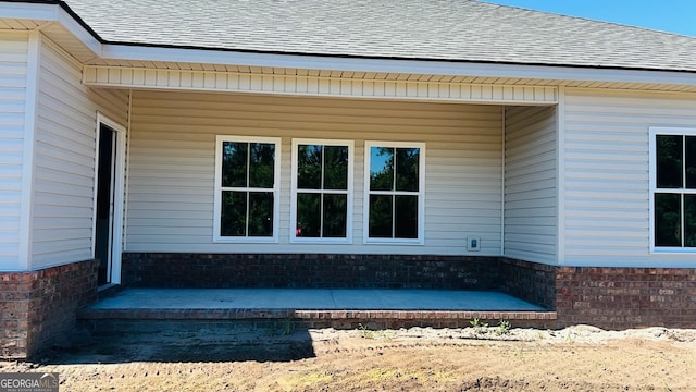 519 Doyle Ln Unit 24, Statesboro, GA 30458 - view of property exterior with a shingled roof and brick siding