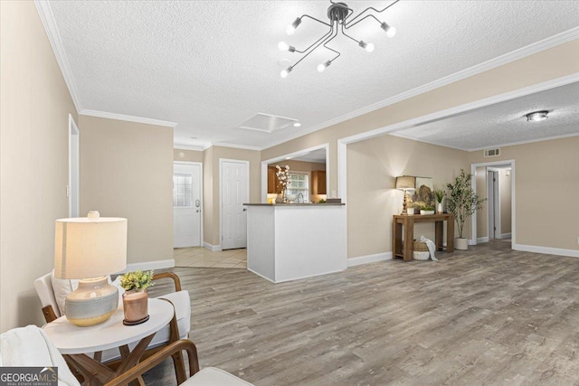 living room with baseboards, a textured ceiling, light wood finished floors, and a notable chandelier