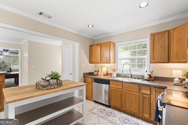 kitchen featuring stainless steel dishwasher, crown molding, visible vents, butcher block countertops, and a sink