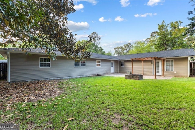 rear view of house with a lawn, a patio area, and fence