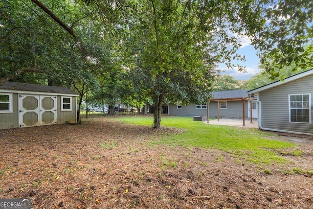 view of yard featuring a storage shed and an outbuilding