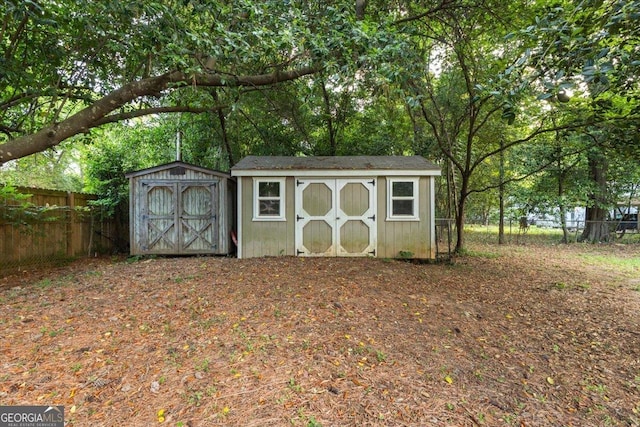 view of shed featuring fence