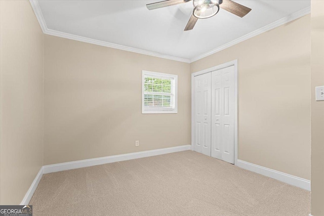 unfurnished bedroom with carpet floors, ornamental molding, and baseboards
