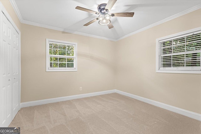 unfurnished bedroom with a closet, carpet flooring, baseboards, and ornamental molding