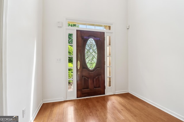 entrance foyer featuring light wood finished floors and baseboards