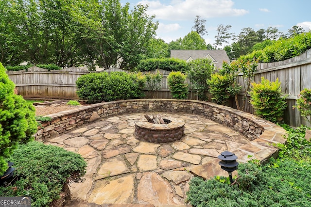 view of patio featuring a fenced backyard and a fire pit