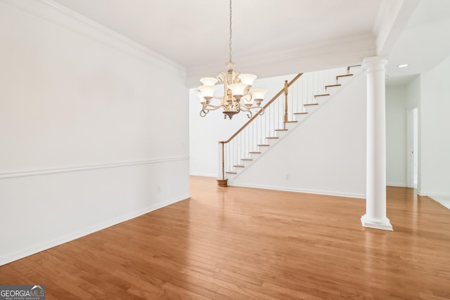 unfurnished dining area with crown molding, baseboards, light wood finished floors, and a chandelier