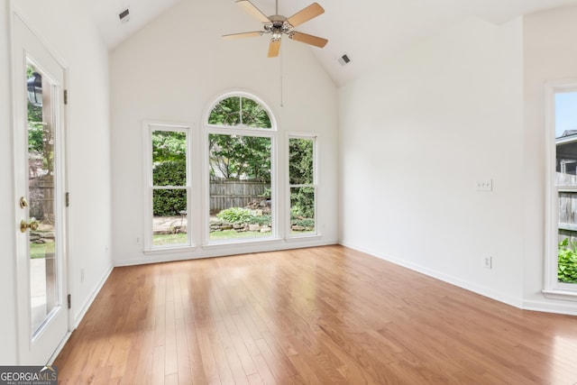 spare room with light wood-style floors, plenty of natural light, and a ceiling fan
