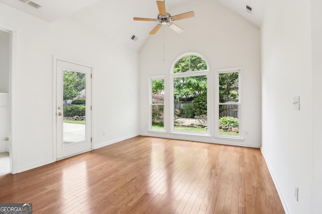 empty room with hardwood / wood-style floors, a ceiling fan, and visible vents