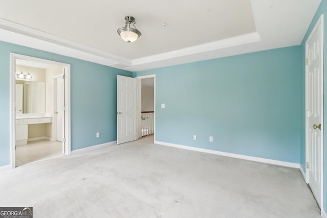 unfurnished bedroom featuring baseboards, carpet flooring, and ensuite bath