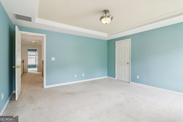unfurnished room featuring visible vents, a raised ceiling, carpet floors, and baseboards