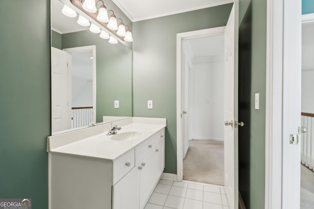 bathroom with vanity, ornamental molding, baseboards, and tile patterned flooring