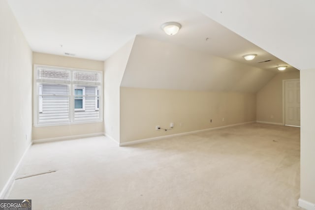 bonus room featuring baseboards and carpet