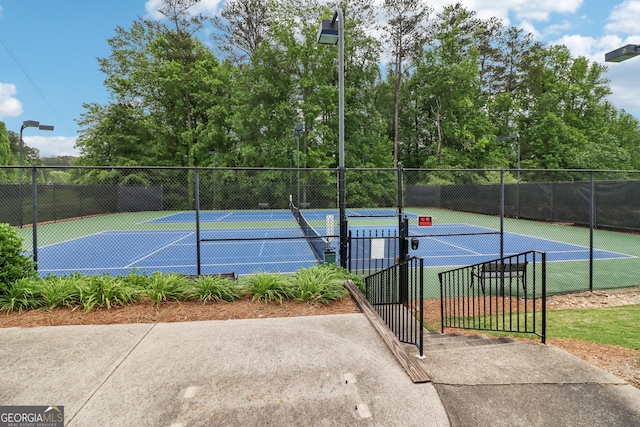 view of sport court featuring fence