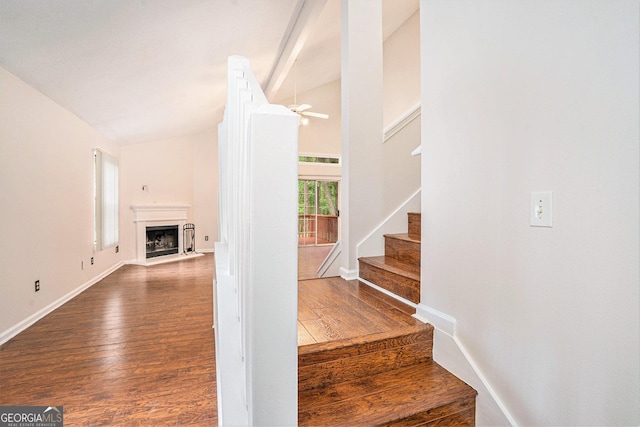 4795 Wilkins Station Dr, Decatur, GA 30035 - stairway featuring wood finished floors, baseboards, ceiling fan, a fireplace with flush hearth, and vaulted ceiling