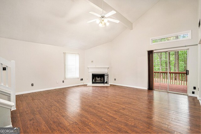 4795 Wilkins Station Dr, Decatur, GA 30035 - unfurnished living room with high vaulted ceiling, plenty of natural light, a fireplace with raised hearth, hardwood / wood-style flooring, and a ceiling fan