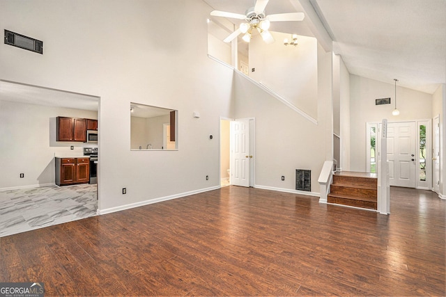 4795 Wilkins Station Dr, Decatur, GA 30035 - unfurnished living room with visible vents, baseboards, ceiling fan, dark wood-style floors, and high vaulted ceiling