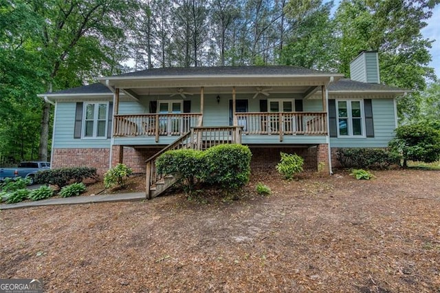 5873 Trellis Ct, Powder Springs, GA 30127 - view of front facade with covered porch, a ceiling fan, stairs, and a chimney