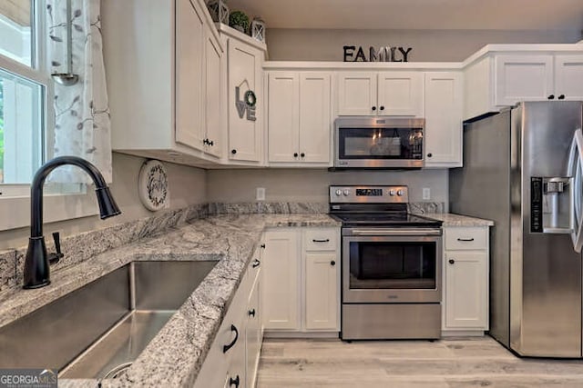 346 Woodland Ln, Hayesville, NC 28904 - kitchen featuring stainless steel appliances, white cabinetry, and a sink