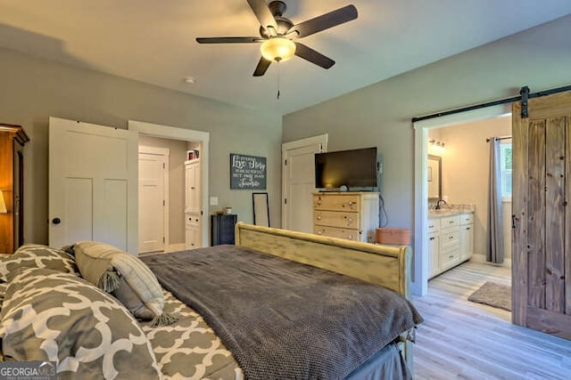 346 Woodland Ln, Hayesville, NC 28904 - bedroom featuring ensuite bathroom, a barn door, light wood finished floors, and ceiling fan