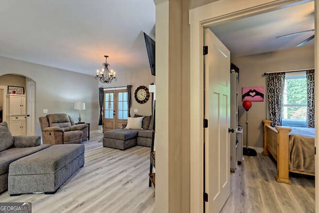 346 Woodland Ln, Hayesville, NC 28904 - interior space with french doors, arched walkways, baseboards, ceiling fan with notable chandelier, and light wood-style floors