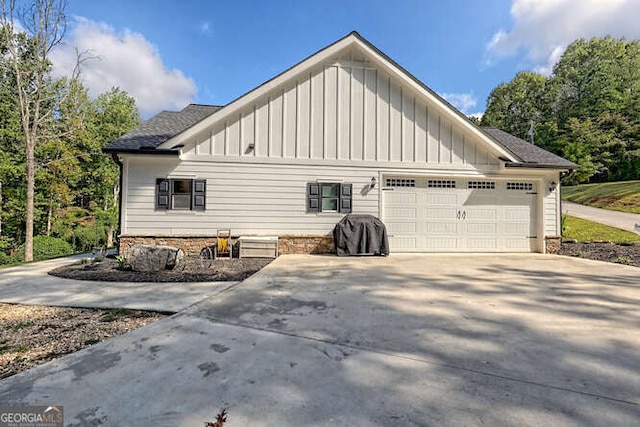 346 Woodland Ln, Hayesville, NC 28904 - view of home's exterior featuring board and batten siding, an attached garage, driveway, and roof with shingles