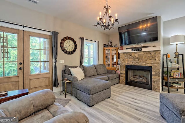 346 Woodland Ln, Hayesville, NC 28904 - living area with a wealth of natural light, a fireplace, light wood finished floors, and a notable chandelier