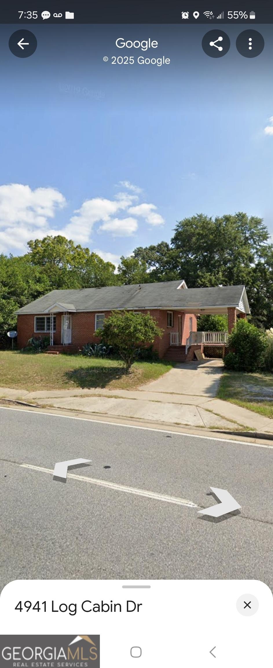 ranch-style house featuring a carport and driveway