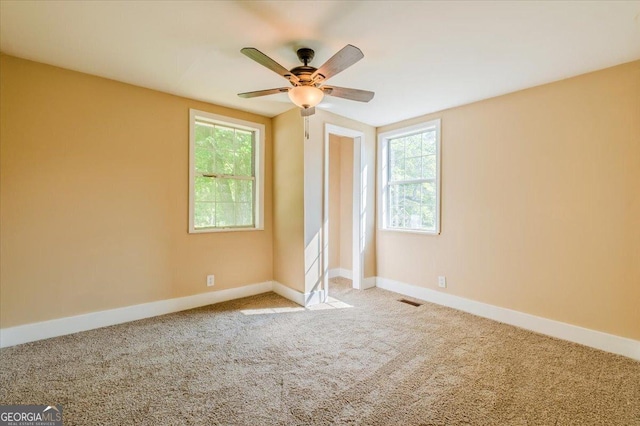 613 Bradley Ave, Lafayette, GA 30728 - carpeted empty room with baseboards, plenty of natural light, a ceiling fan, and visible vents