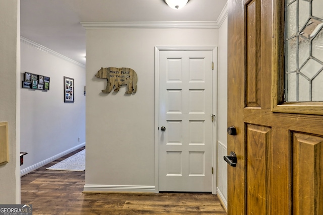 entrance foyer featuring crown molding, baseboards, and dark wood finished floors