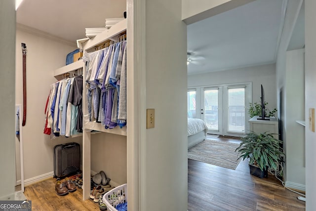 spacious closet with a ceiling fan and wood finished floors