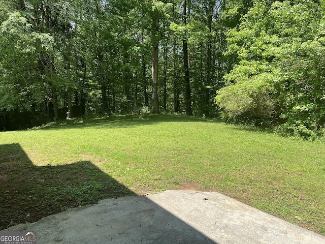view of yard with a view of trees
