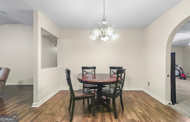 142 Old Hampton Way, Hampton, GA 30228 - dining room featuring arched walkways, baseboards, wood finished floors, and a chandelier