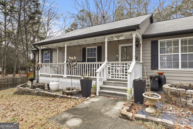 142 Old Hampton Way, Hampton, GA 30228 - view of front of property with a porch, roof with shingles, and fence