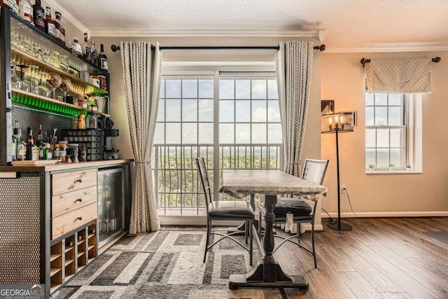 199 14th St Unit 2502, Atlanta, GA 30309 - interior space with a dry bar, hardwood / wood-style floors, baseboards, wine cooler, and ornamental molding