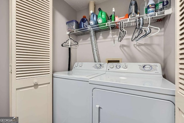 199 14th St Unit 2502, Atlanta, GA 30309 - washroom with separate washer and dryer, laundry area, and a textured ceiling