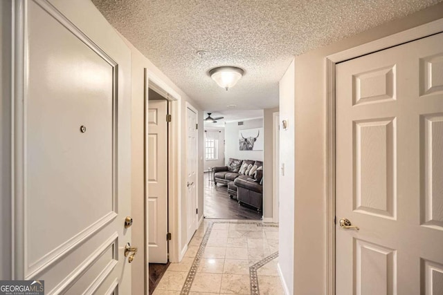 199 14th St Unit 2502, Atlanta, GA 30309 - hall featuring baseboards and a textured ceiling