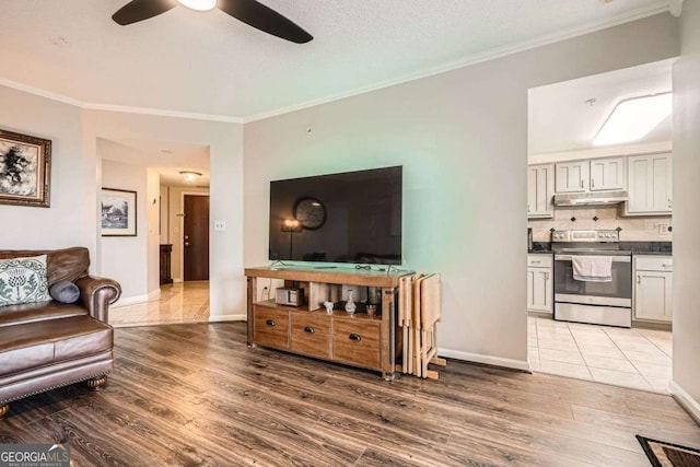 199 14th St Unit 2502, Atlanta, GA 30309 - living area featuring baseboards, ornamental molding, a ceiling fan, and wood finished floors