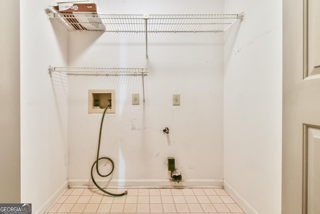 clothes washing area featuring washer hookup, baseboards, and laundry area