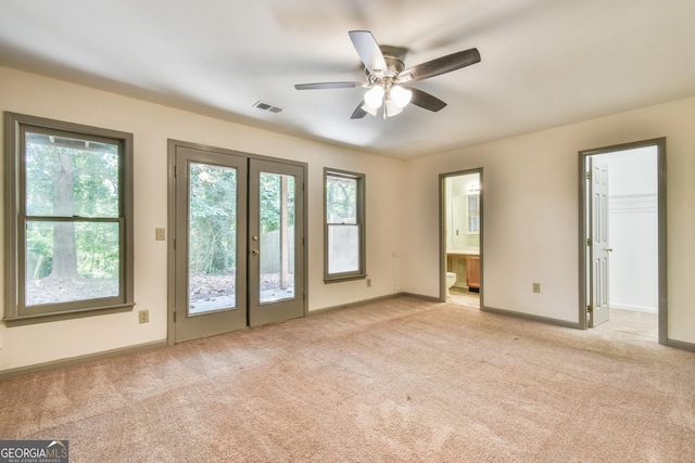 interior space featuring light colored carpet, visible vents, and a wealth of natural light