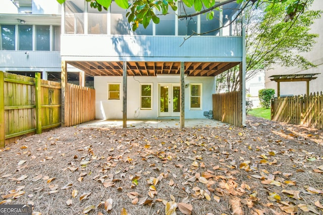 back of house with french doors, a fenced backyard, a patio area, and stucco siding