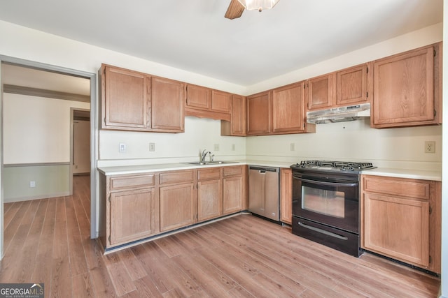 kitchen with a sink, light countertops, black range with gas cooktop, stainless steel dishwasher, and under cabinet range hood