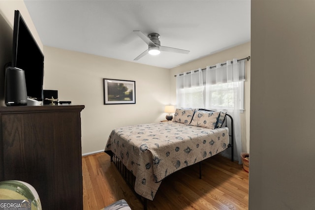 bedroom with a ceiling fan and wood finished floors