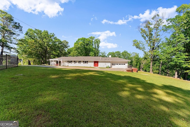 exterior space with fence and a front yard