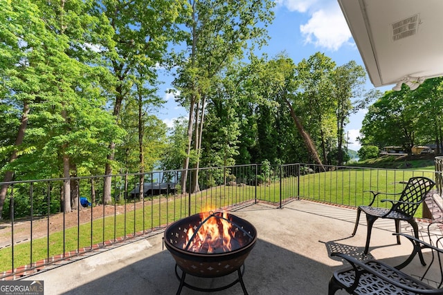 view of patio / terrace featuring visible vents and an outdoor fire pit