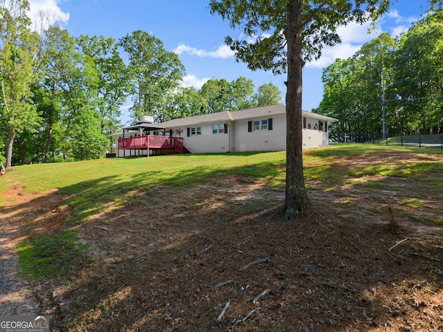view of yard featuring fence and a deck