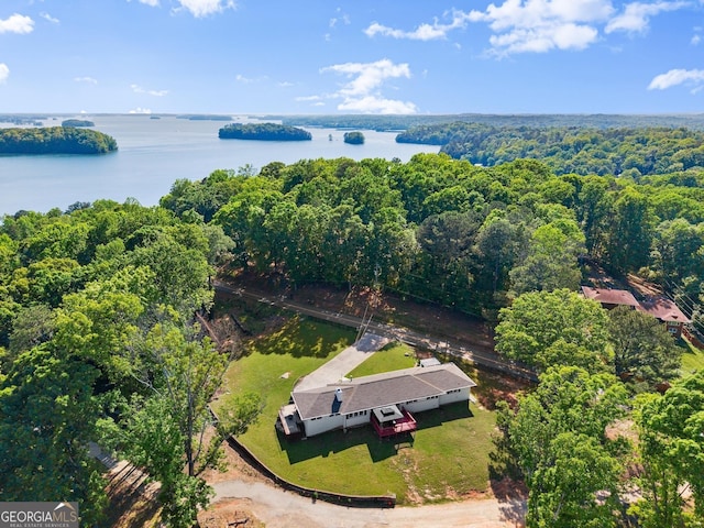 aerial view with a water view and a wooded view