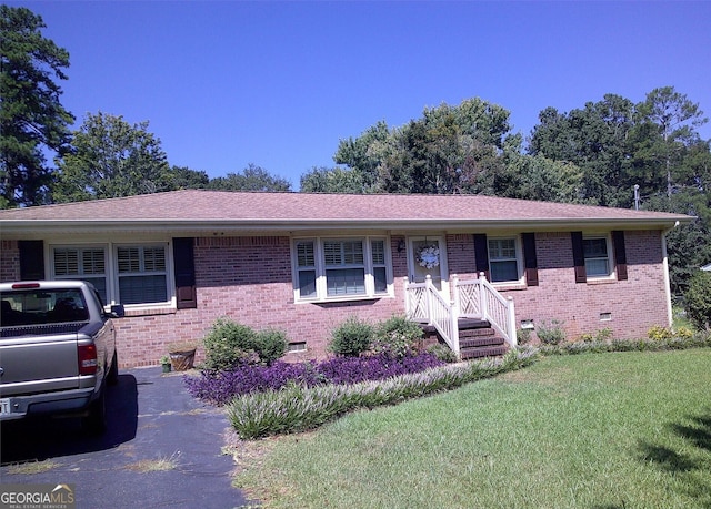 single story home with brick siding, a shingled roof, crawl space, and a front yard