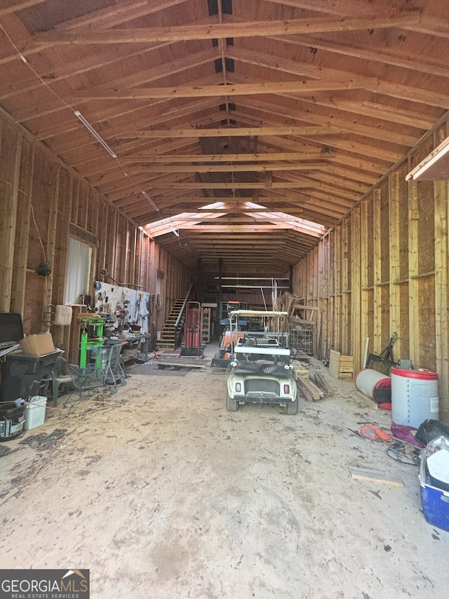 miscellaneous room with a garage and vaulted ceiling