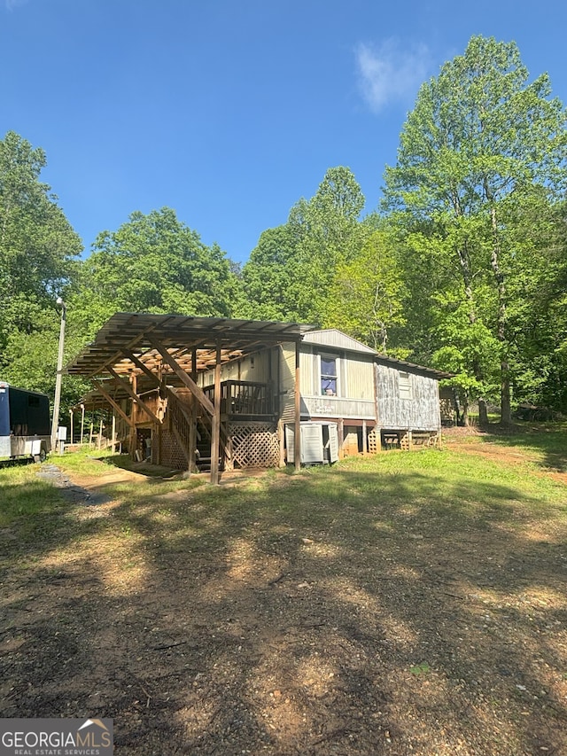 exterior space featuring a wooden deck and stairs